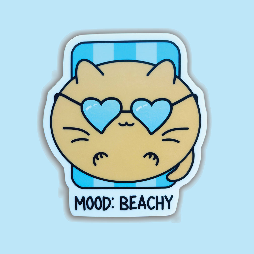 cat on beach blanket with mood beachy words on it