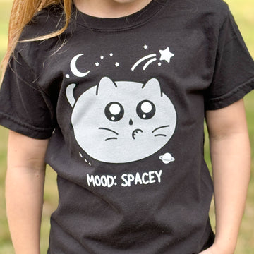shirt with a cat illustration of a cat in outer space and mood spacey words